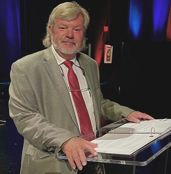 Gary Miller in a grey suit and red tie